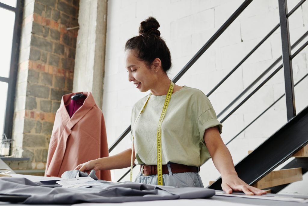 Self Employed Fashion Designer Looking At Sketch Of Seasonal Collection Items - Contabilidade em Florianópolis - SC | Tecplan Contabilidade